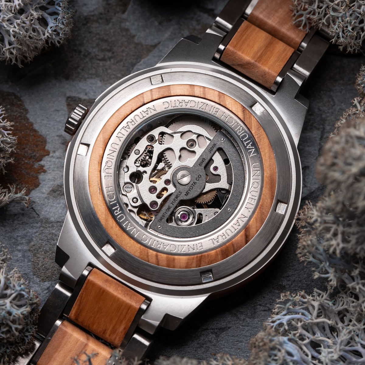 "Haiku", a watch with an olive-themed design, showcasing intricate machinery and a wooden accent.
