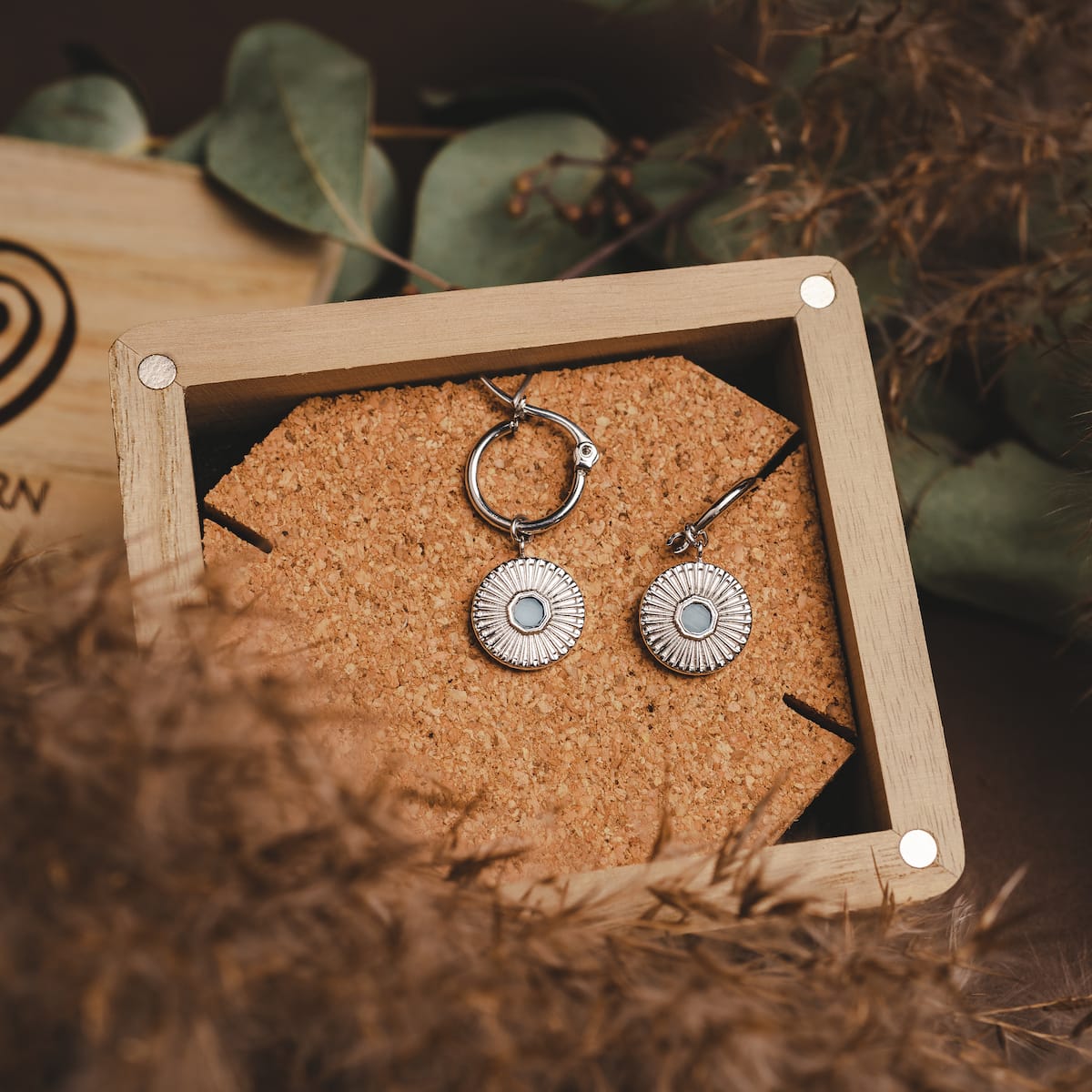 "Stencil Earrings": Elegant silver earrings with aquamarine accents, featuring a stylish stencil design.