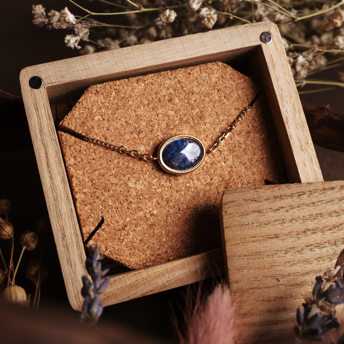 "Mirror Bracelet" bracelet featuring a lapis lazuli stone set in gold, displayed in an elegant wooden box.