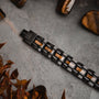 "Tremolo" bracelet featuring zebrawood and black accents on a textured surface.
