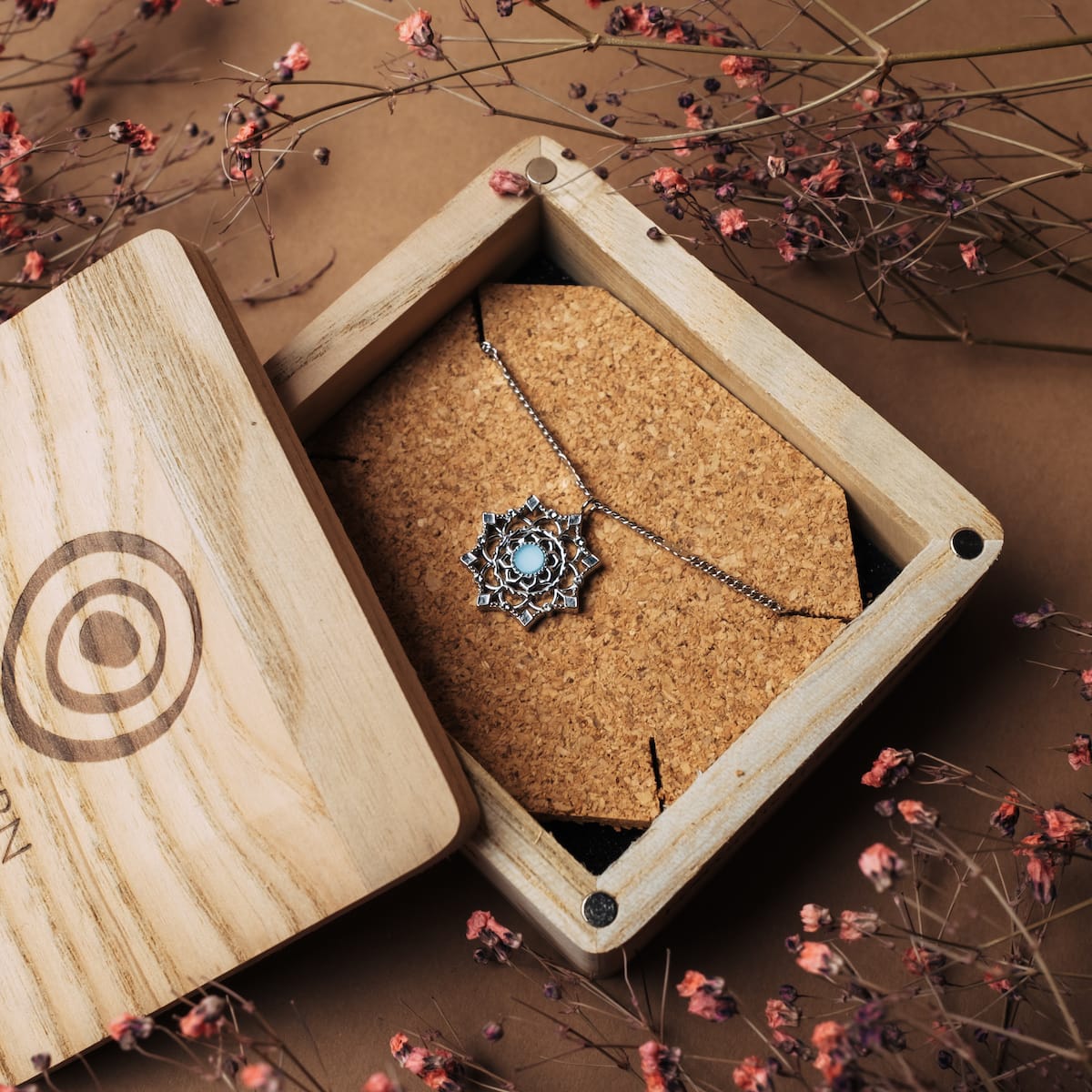 "Aphonia Necklace" necklace, aquamarine and silver, showcased in a decorative floral box setting.