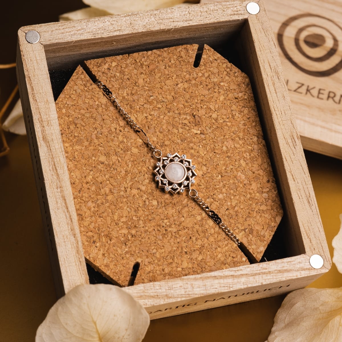 "Composition Gem Bracelet" Bracelet features a moonstone in rose gold with an elegant, rustic style showcased in a wooden box.