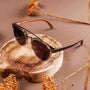 "The Trustworthy" sunglasses feature a sleek wood and ash design, blending natural elegance with modern style.