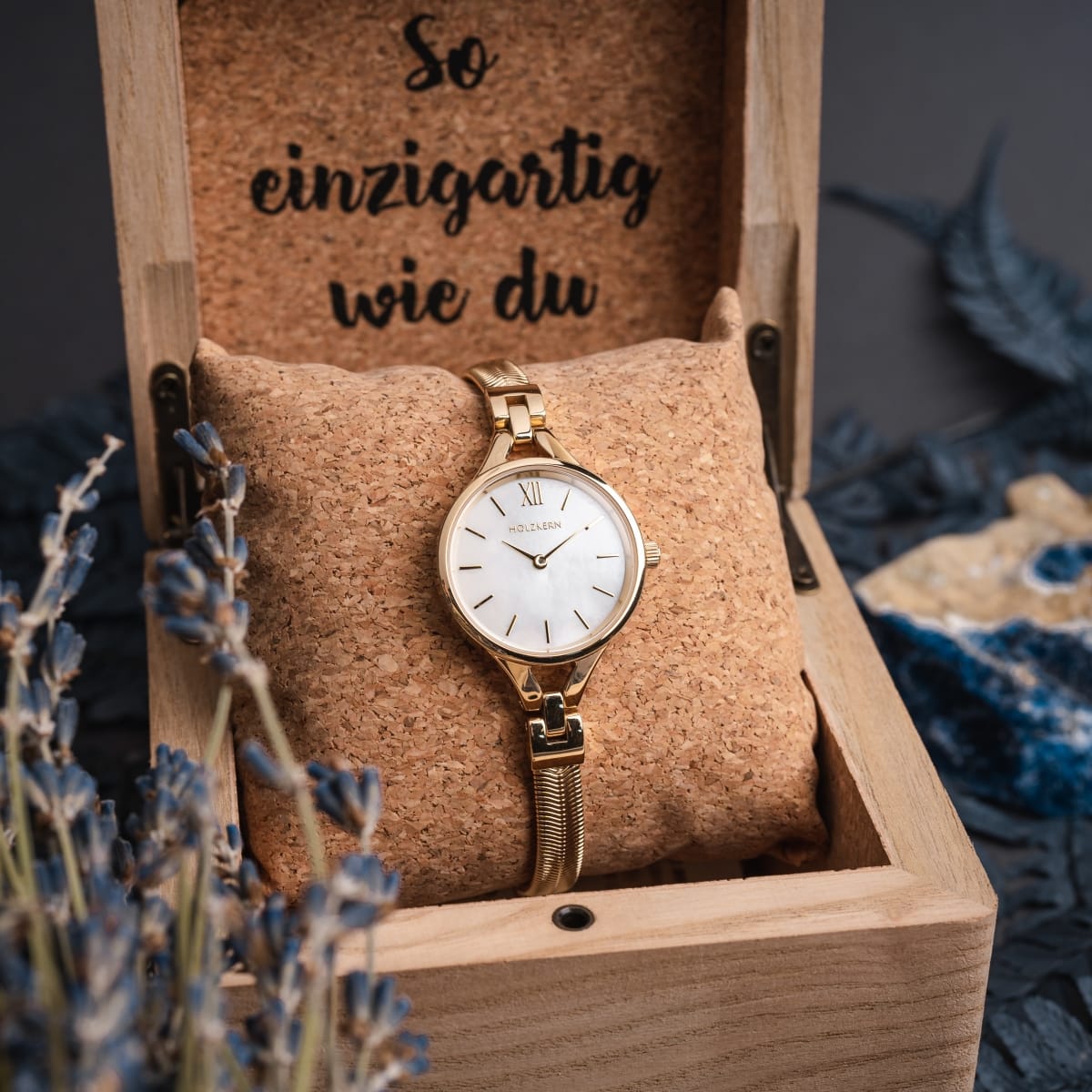 "Kaliya" watch featuring a gold and nacre design, elegantly displayed in a wooden box.