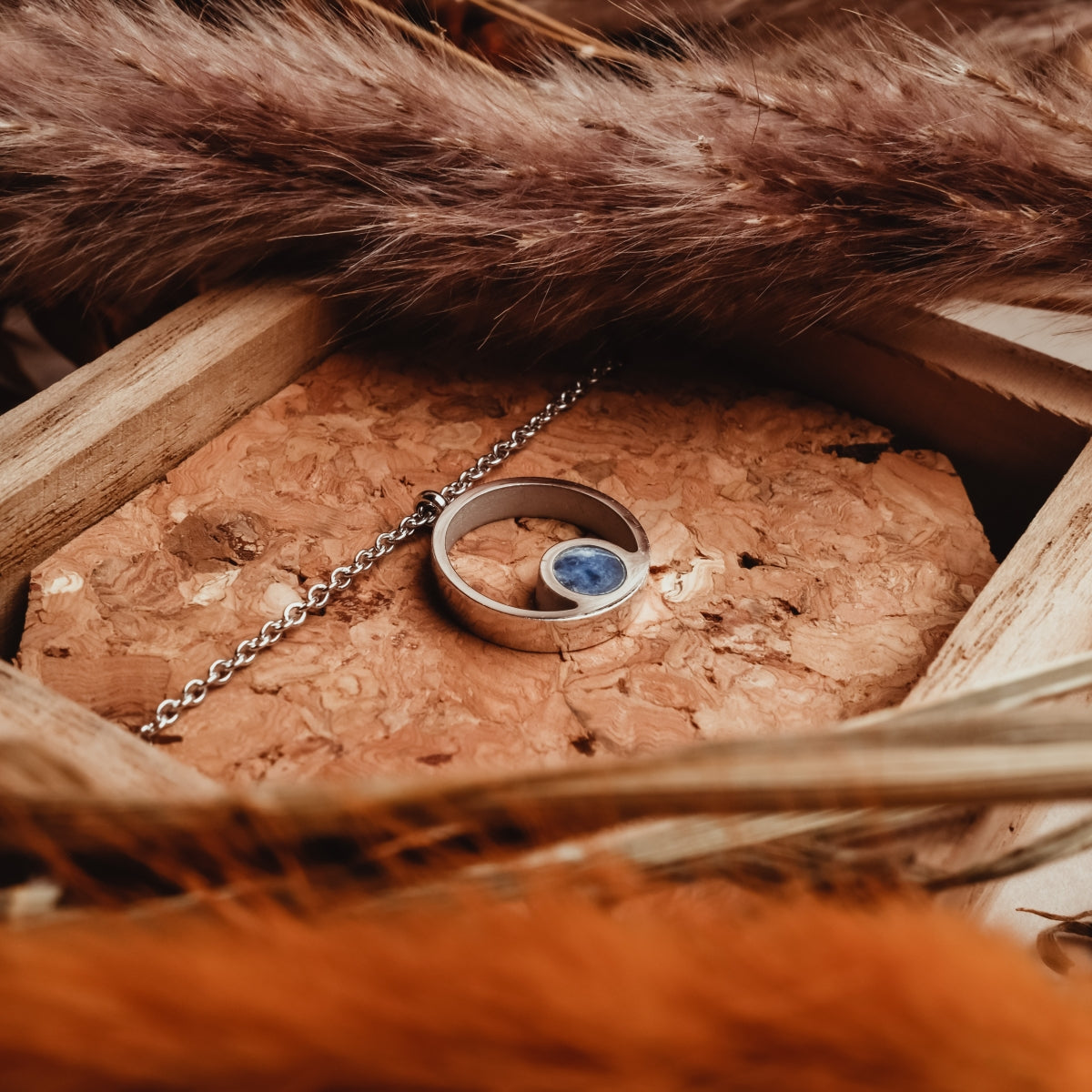 "Pigment Necklace", a marble and silver necklace, with a sleek and elegant design.