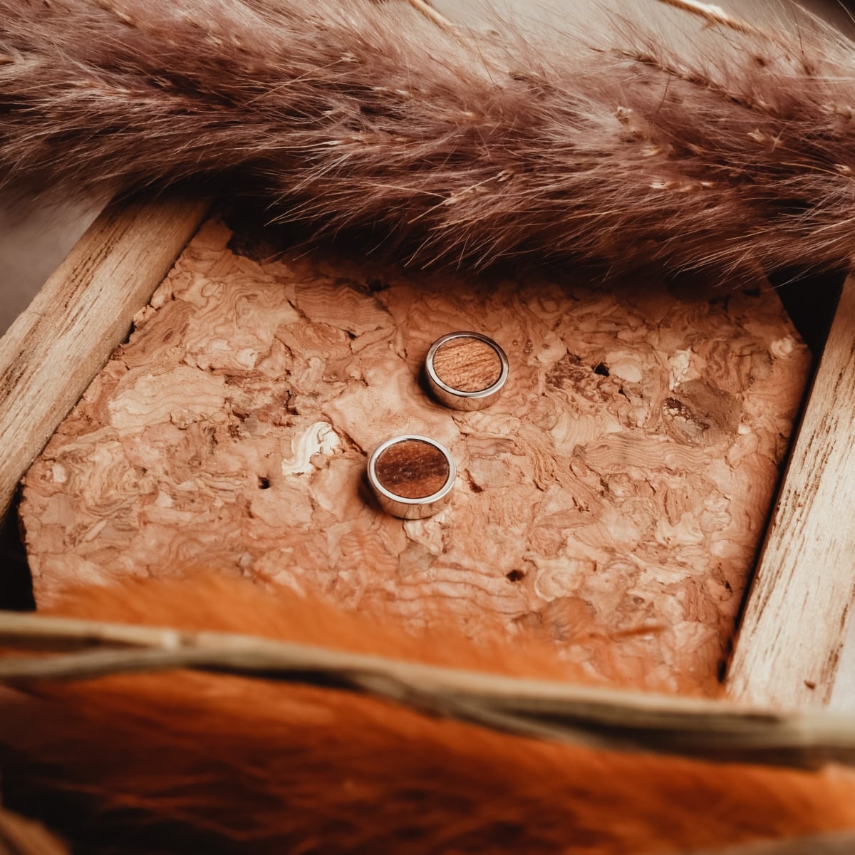 "Pigment Earrings" earrings feature a natural koa wood and silver design, exuding a stylish and earthy aesthetic.