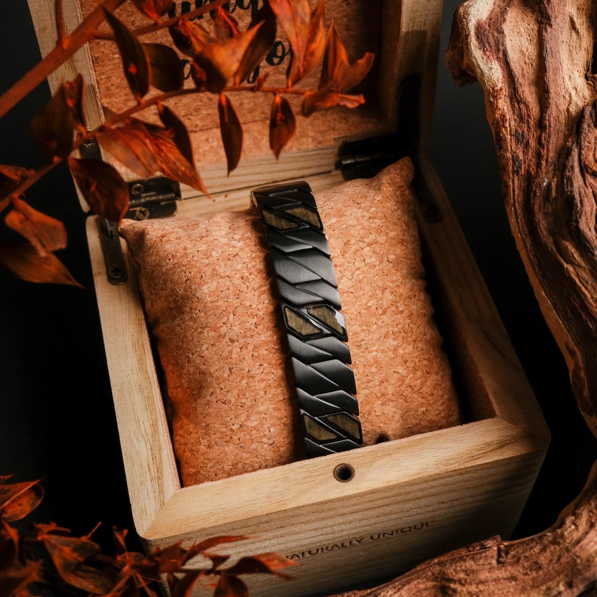 "Baritone" bracelet featuring a sleek maple and black design, elegantly displayed in a wooden box.