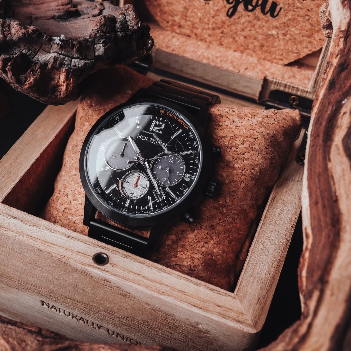 "Rahotu" watch featuring a marble and black design in a rustic wooden box.