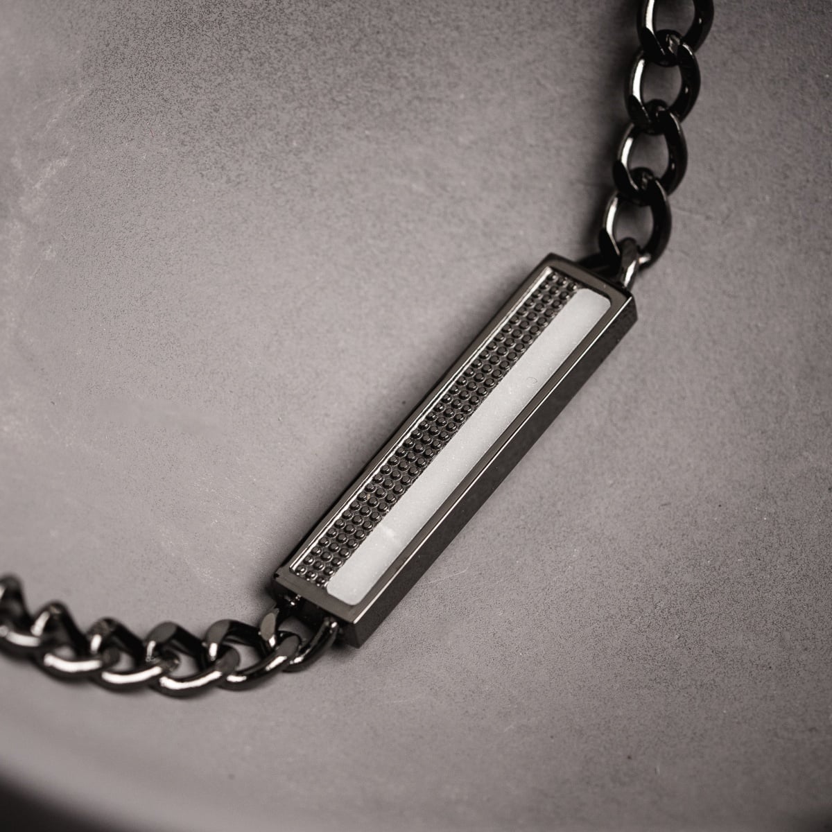 "Planarity Bracelet" bracelet featuring a marble and dark grey design with a sleek, modern aesthetic.