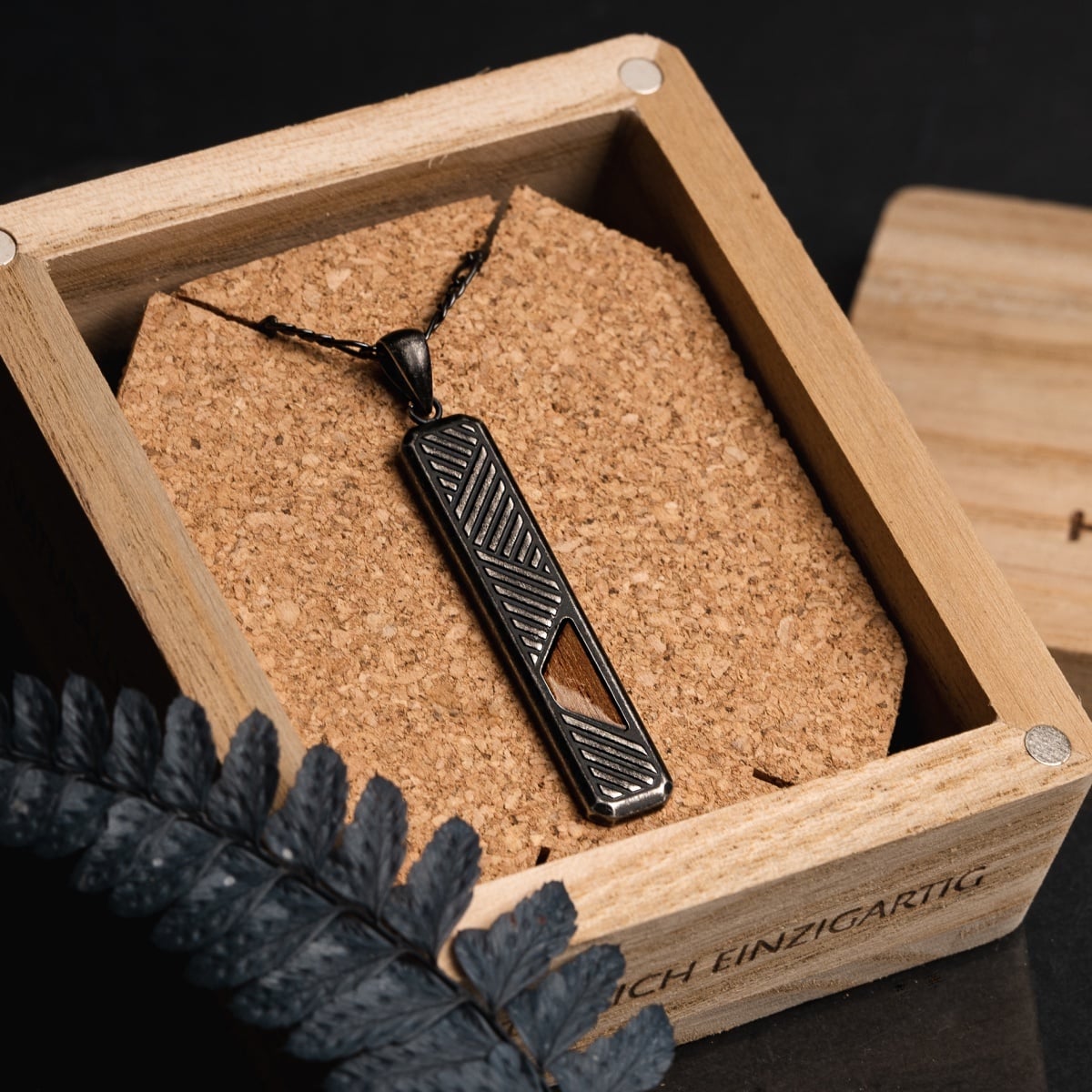 “Derivatives Necklace” necklace featuring Walnut and antique silver design in an elegant, geometric style.