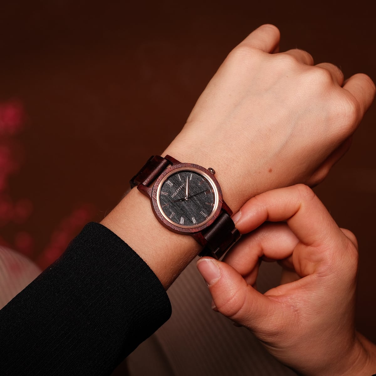 "Passion" wristwatch crafted from Padauk and Maple, featuring a sleek and elegant design on a wrist.