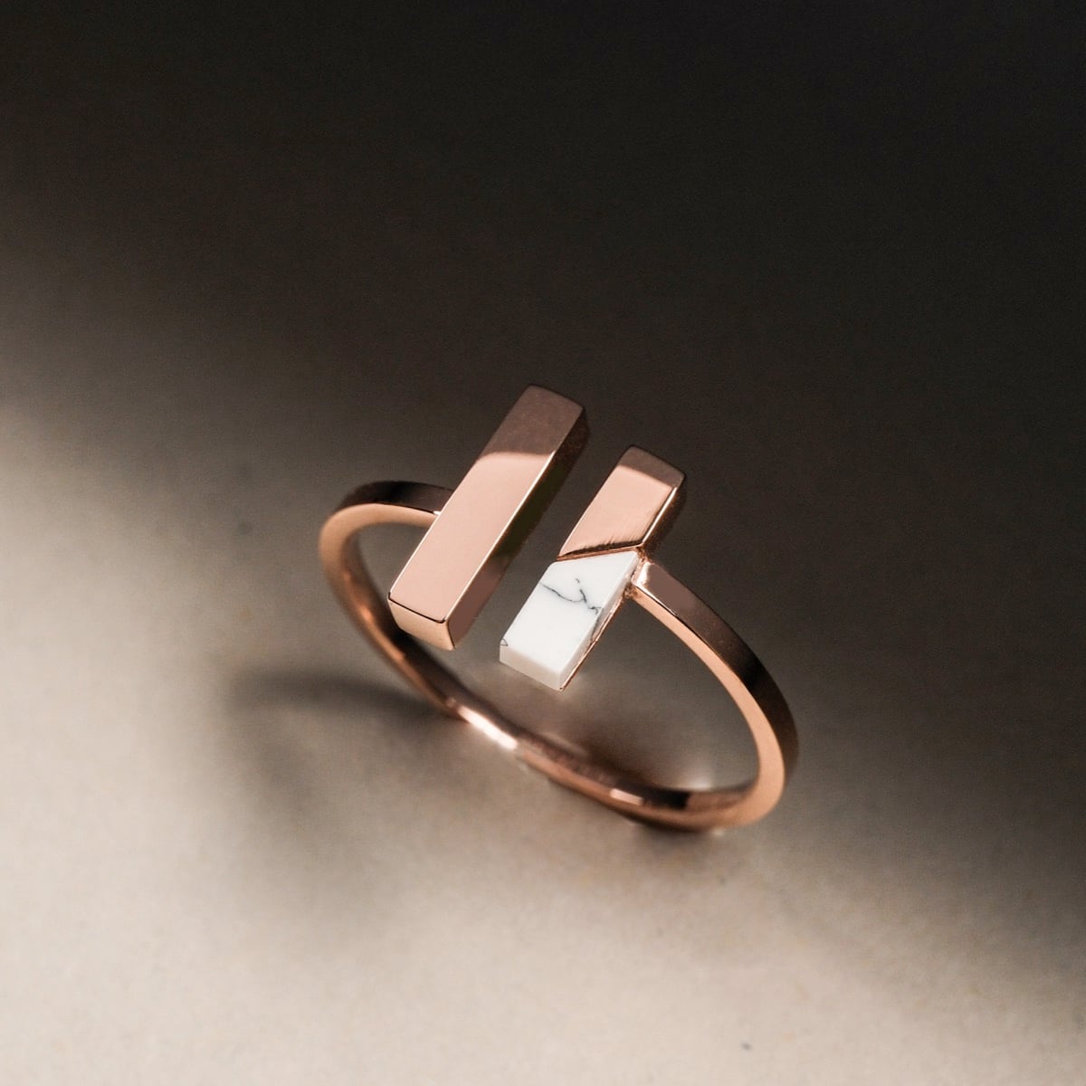"Campania Ring" features a modern, minimalist ring design with marble and rose gold accents.