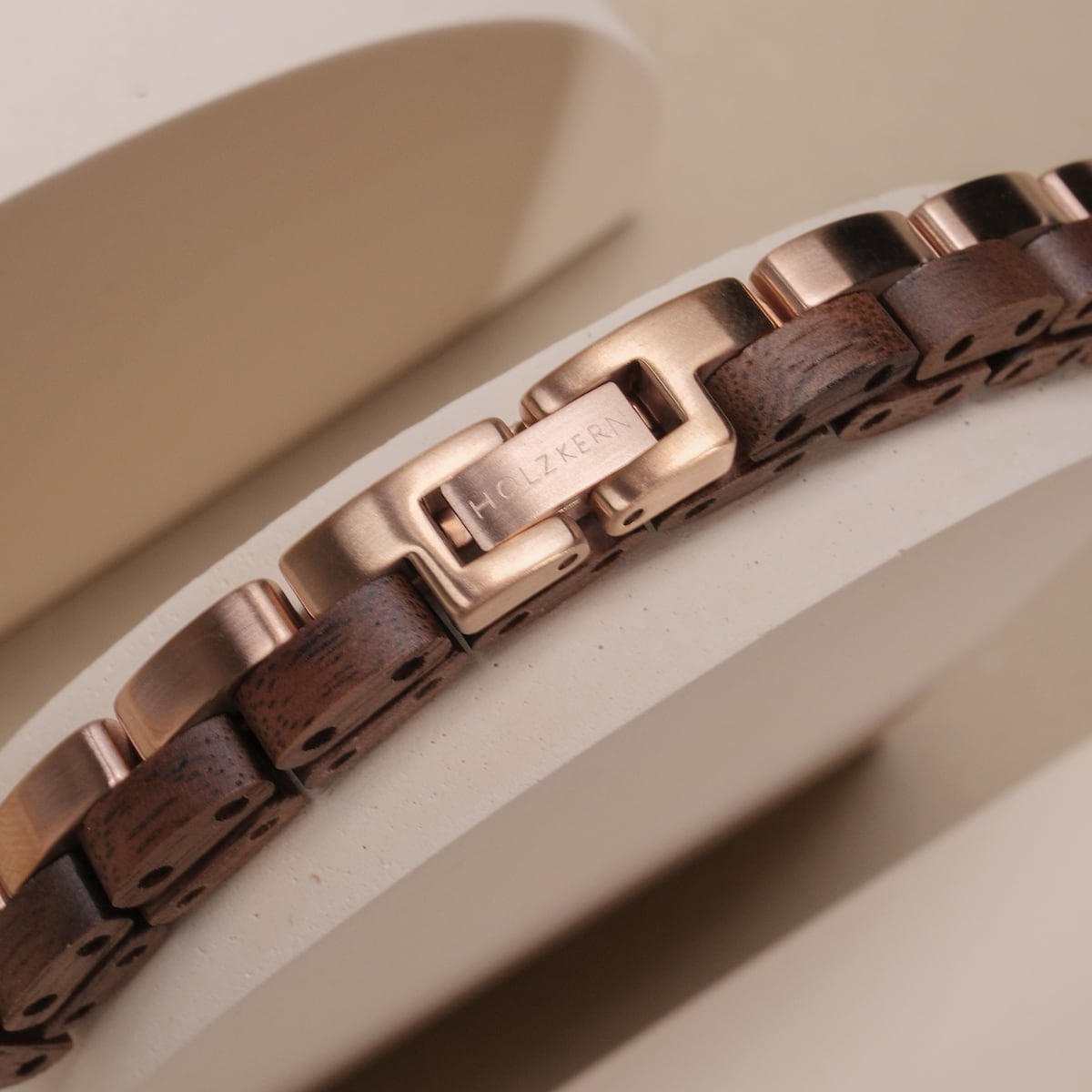 "Duet", an elegant bracelet featuring walnut wood and rose gold accents, showcases sophisticated style and craftsmanship.