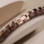 "Duet", an elegant bracelet featuring walnut wood and rose gold accents, showcases sophisticated style and craftsmanship.