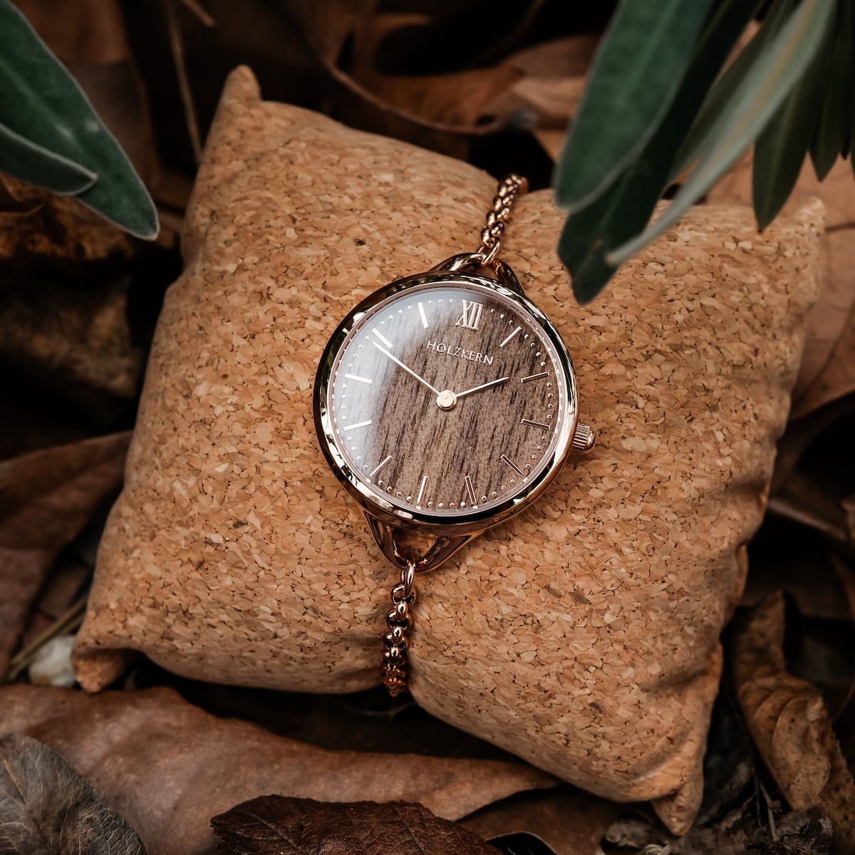"Blissed" watch featuring a walnut face and rose gold accents, styled on a natural background with earthy tones.