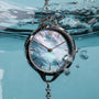 "Brighter" watch with nacre and silver styling, submerged in water.