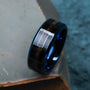 "Cartesian Ring" ring featuring maple wood and a sleek blue band for a modern look.