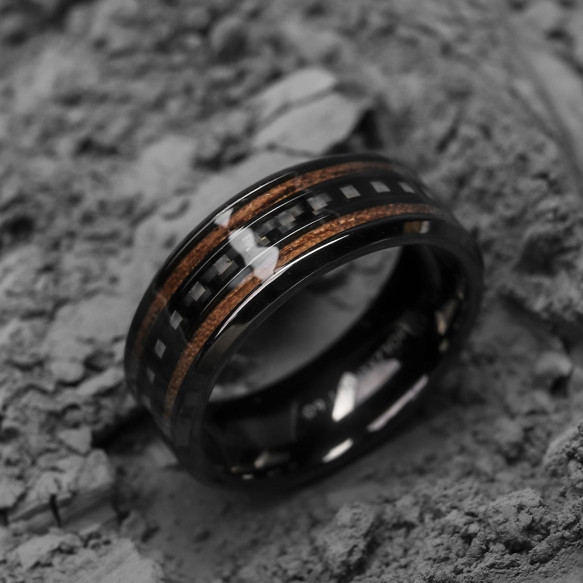 "Cartesian Ring", a stylish ring with walnut and carbon elements, showcasing a modern, earthy design.
