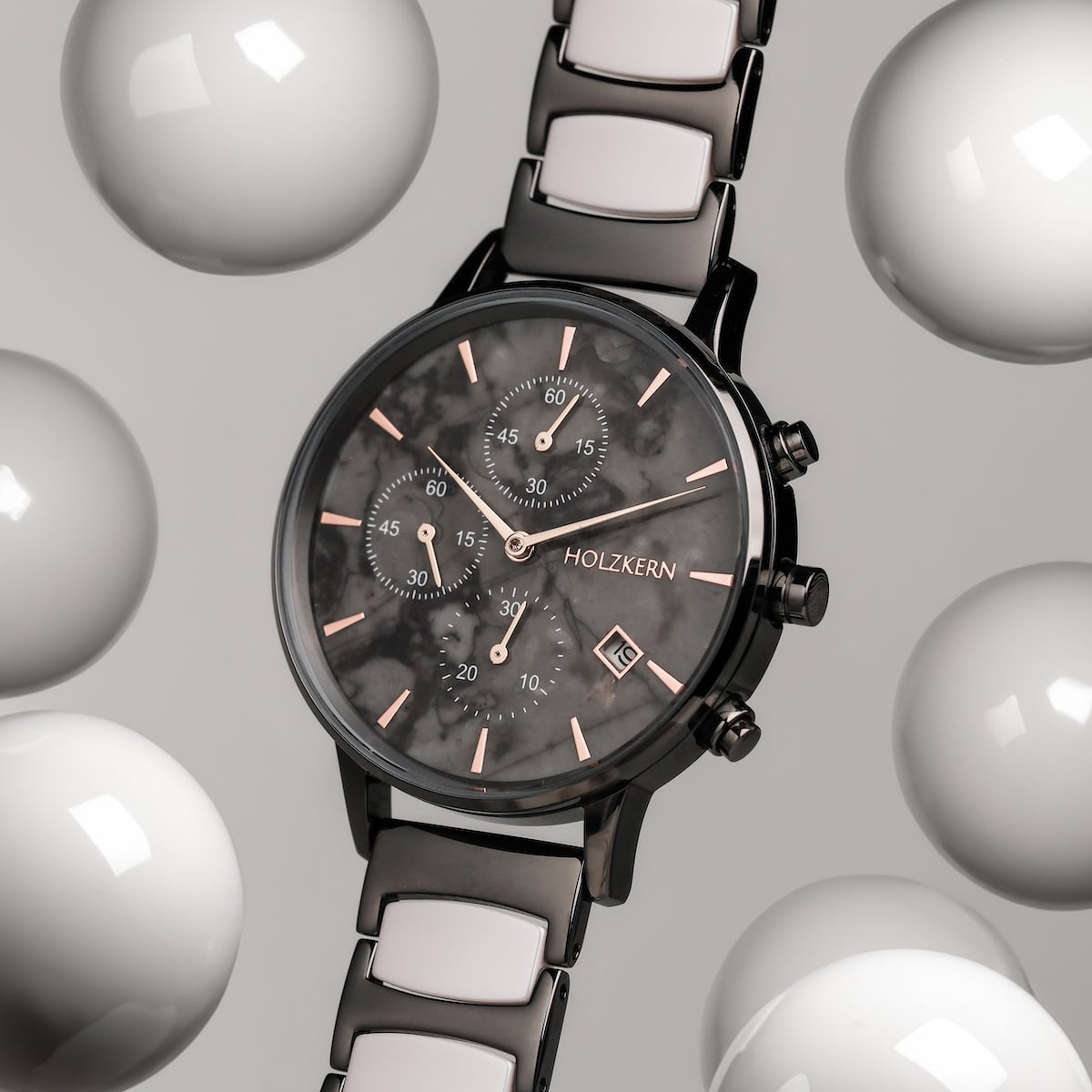 "Breezy watch with marble face and ceramic strap, surrounded by floating spheres, modern and elegant design."
