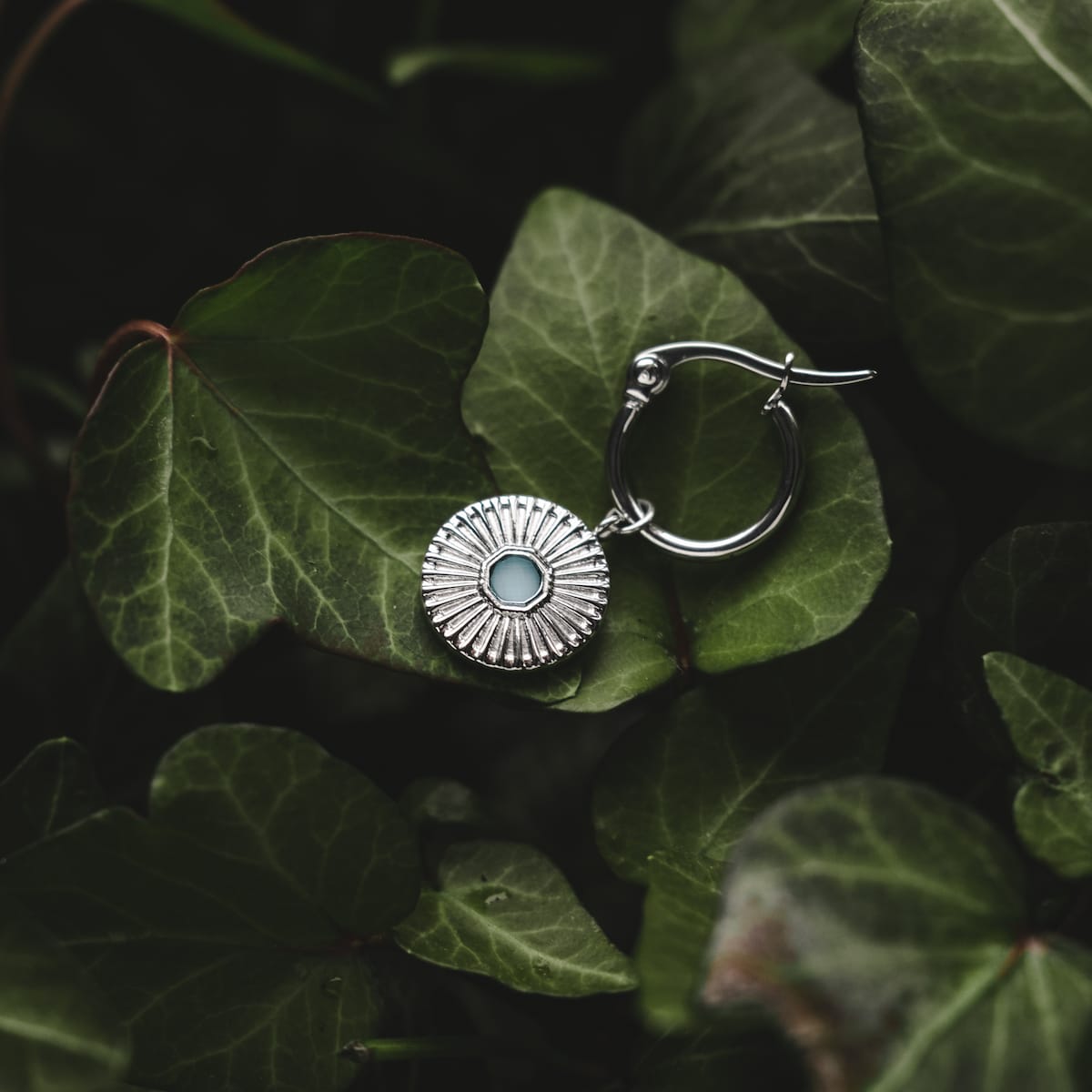 "Stencil Earrings": Elegant silver earrings with aquamarine accents, featuring a unique stencil design.
