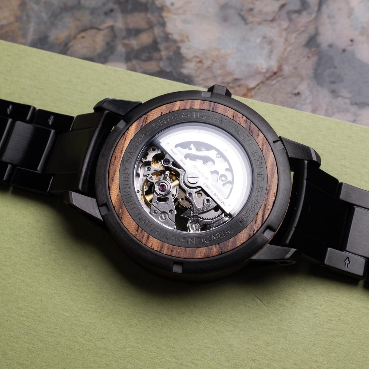 "Sternum", a watch with zebrawood and black accents, showcasing a stylish and intricate open-back design.