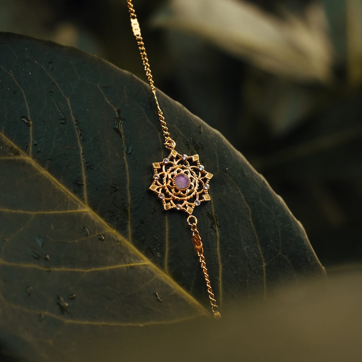 "Aphonia Bracelet" bracelet featuring amethyst and gold, showcasing an intricate design on a natural background.