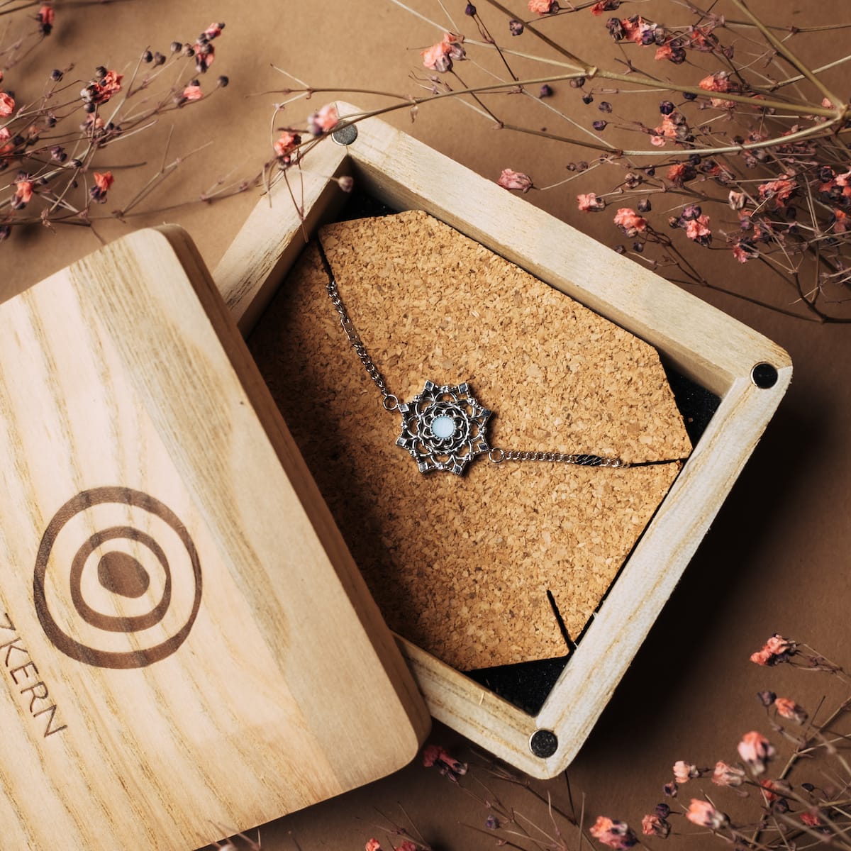"Aphonia Bracelet" bracelet featuring aquamarine and silver, with an elegant, intricate design in a wooden box.