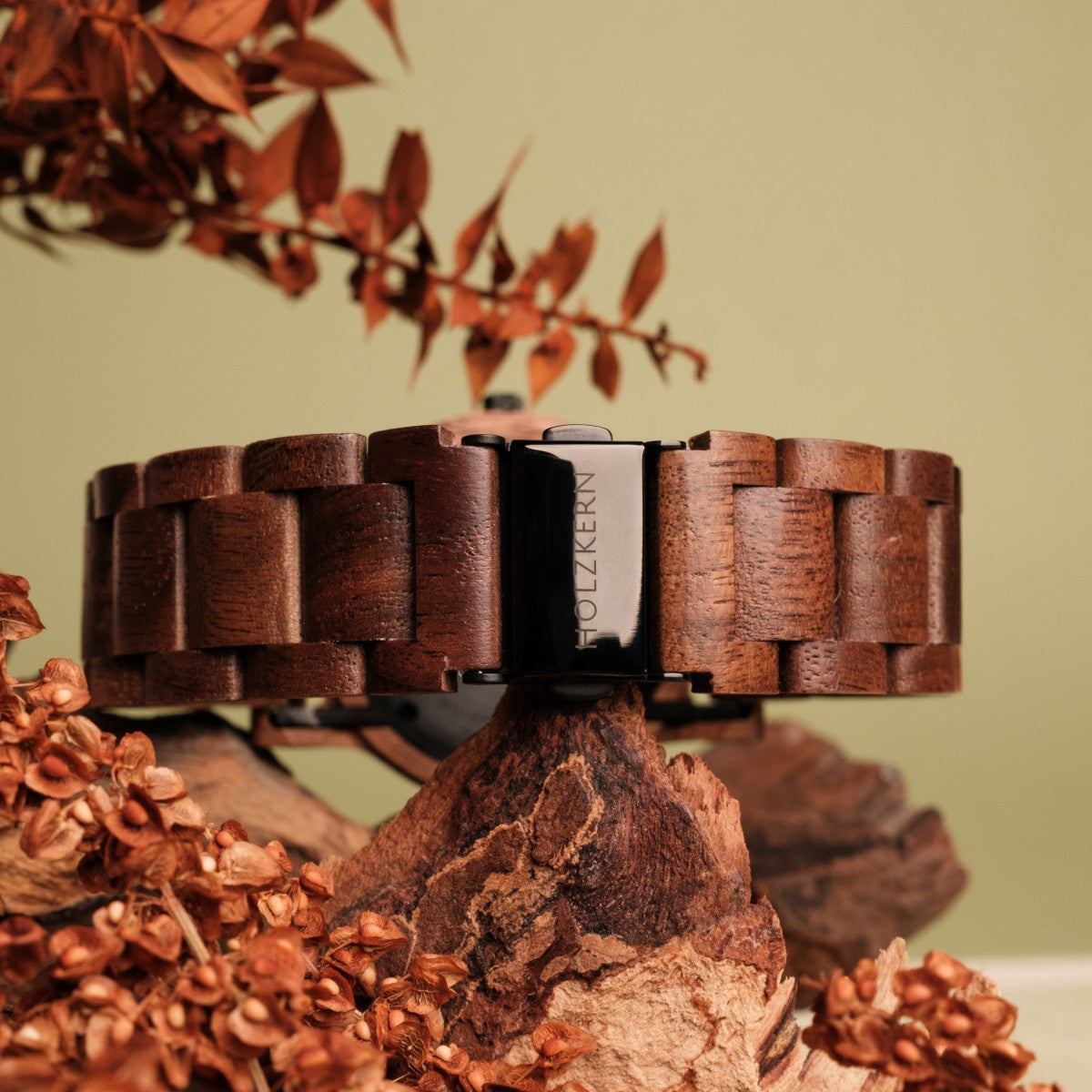 "Spring Evening" wristwatch with a wood-link band in warm Walnut and leadwood tones, styled with rustic floral accents.