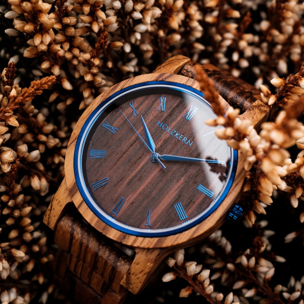 Fall Morning watch with Zebrawood/Wenge finish nestled in autumn flowers, featuring a rustic and elegant design.