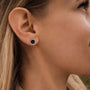 "Facade Earrings" earrings, hexagonal design in marble and silver, worn with elegance.