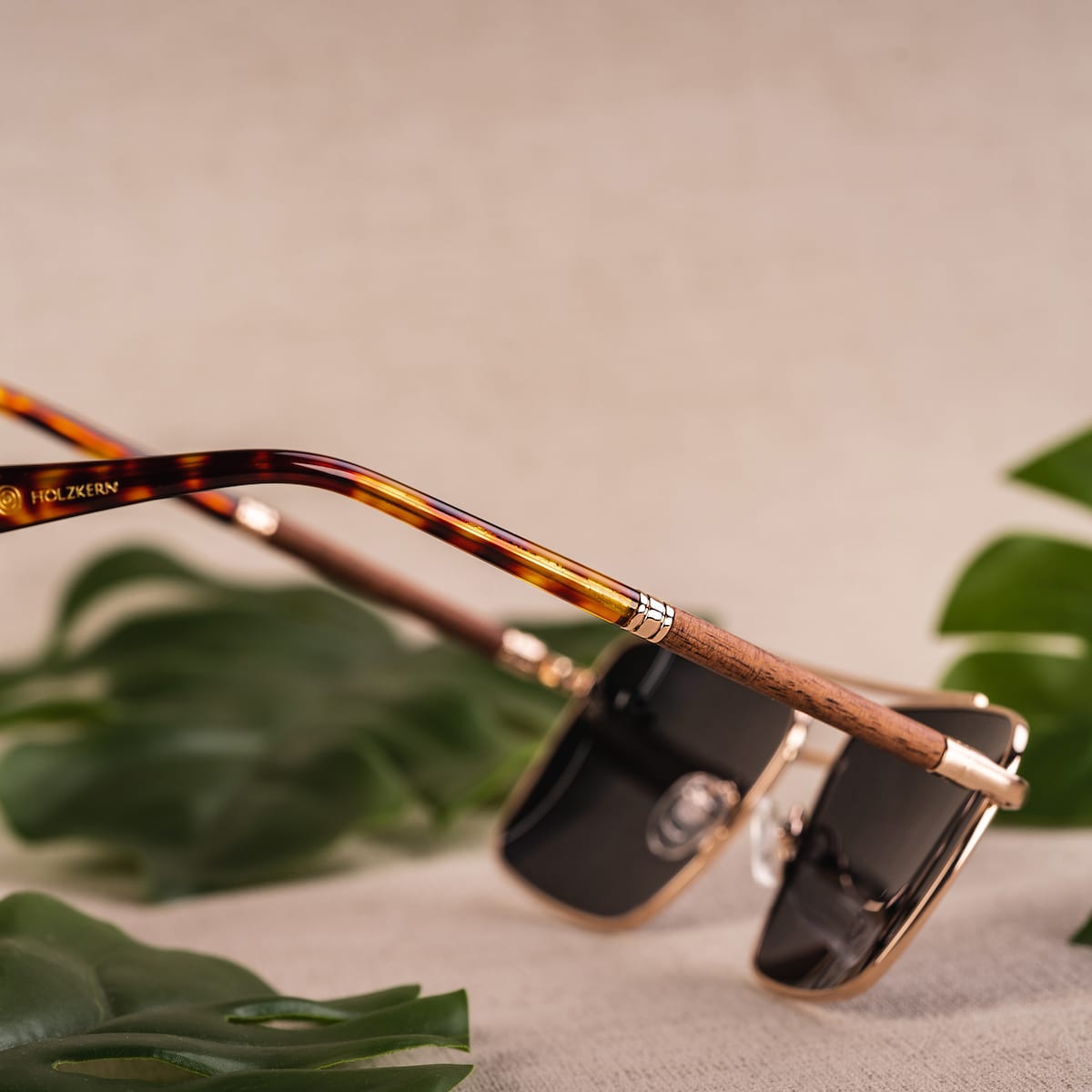"The Talisman" sunglasses featuring a walnut and matte gold design with a stylish and elegant visual appeal.