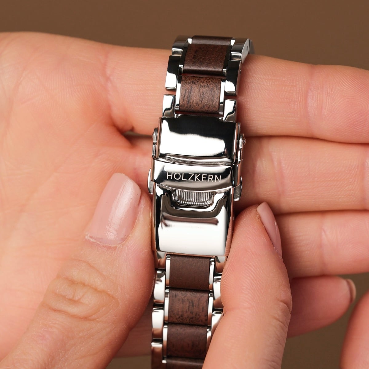 "Colorburst" watch featuring a sleek metallic finish and stylish wood inlay, combining elegance with natural elements.