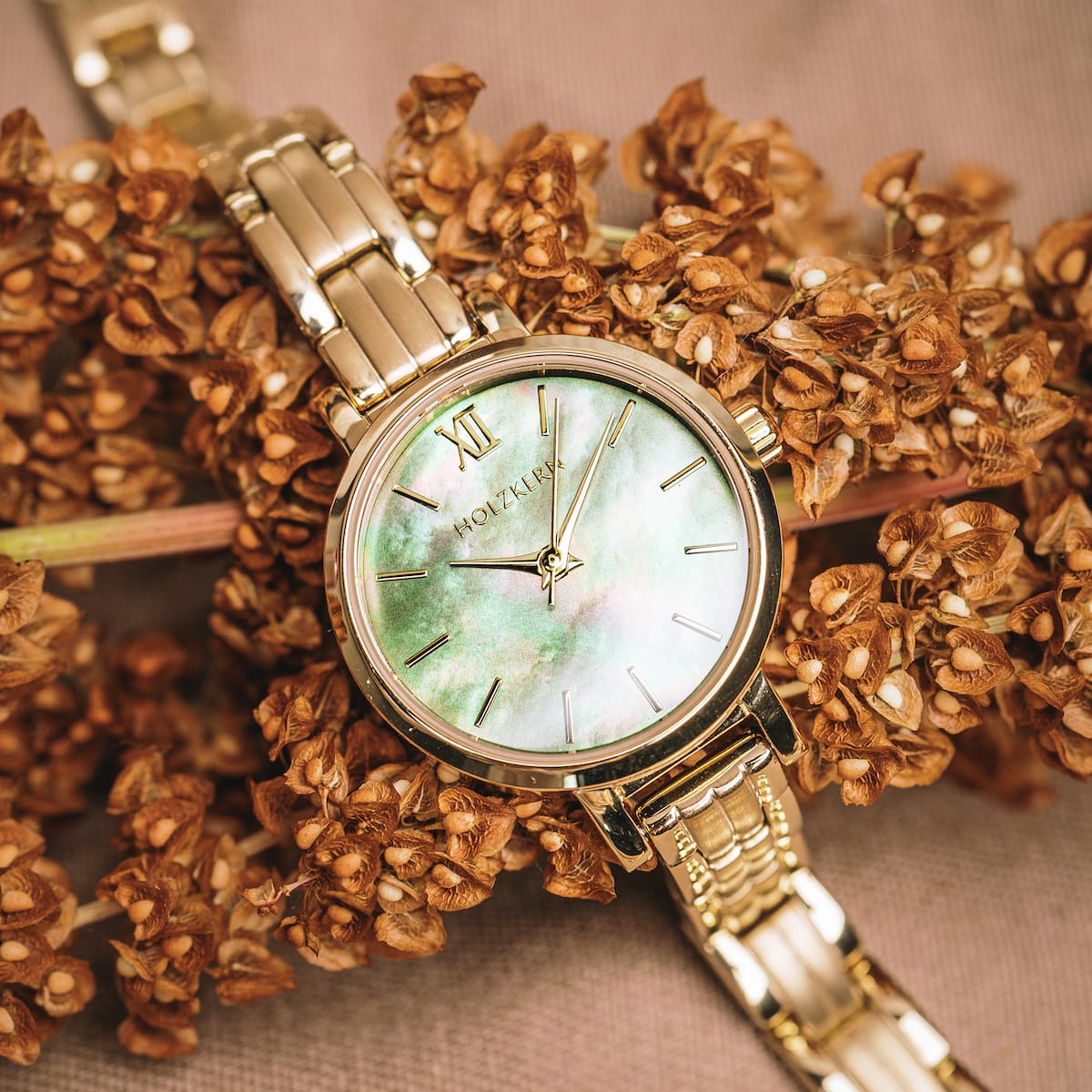 "Themis" watch featuring a nacre dial and gold accents, providing an elegant and sophisticated style.