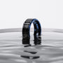 "Cartesian Ring" ring featuring a sleek design with maple and blue accents, elegantly displayed in water.