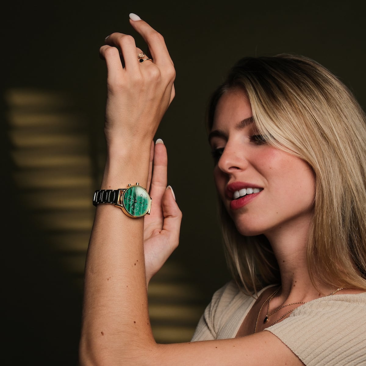 "Jolly" watch featuring a malachite face and ceramic band, showcased on a smiling person.