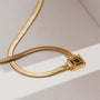 "Awakening Necklace", a gold and marble necklace with a modern, elegant design.