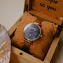 "Giggles" watch featuring a nacre dial and gold mesh band presented in an elegant wooden box.