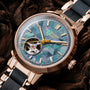 "Luminaire" watch with a nacre and maple design, featuring a geometric-patterned dial and metallic accents.