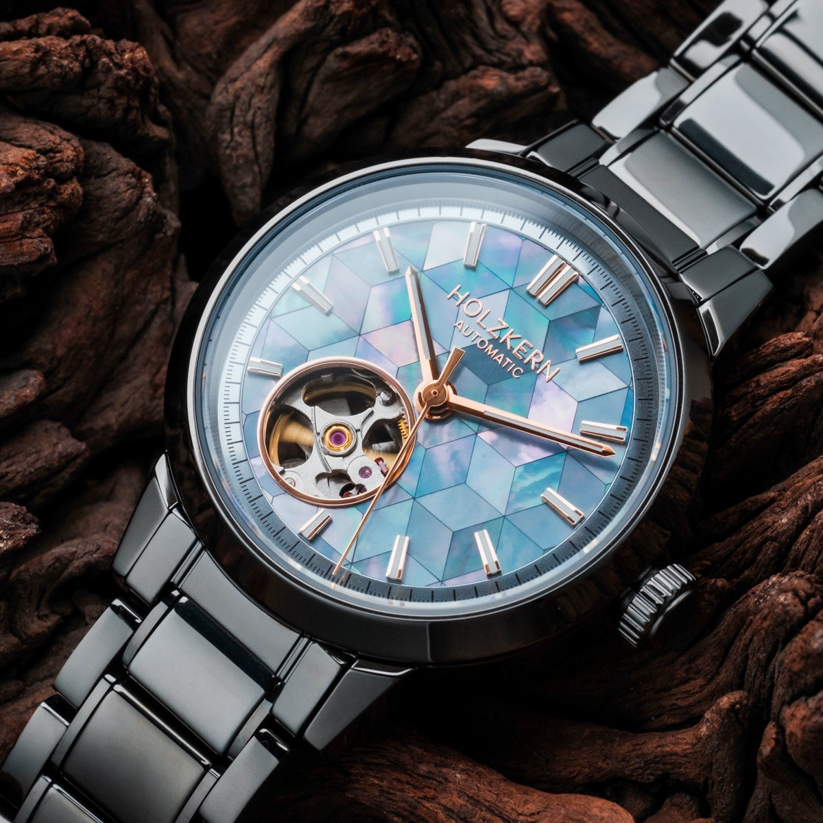 Mirrorance watch featuring a nacre ceramic design with an elegant open-heart dial against a wooden background.