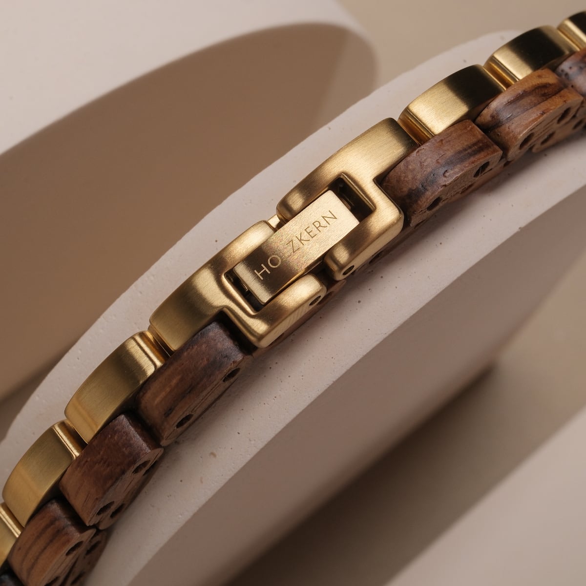 "Duet" watch band featuring zebrawood and gold accents, showcasing a sleek and elegant style.