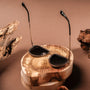 "The Honorable" sunglasses featuring a unique leadwood and silver design, showcased on a natural wood backdrop.