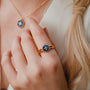"Spectral Ring": Gold ring with a blue nacre design, featuring a modern hexagonal style.