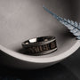 "Countless Ring", a stylish ring with a maple and dark gray design, displayed elegantly in a modern setting.