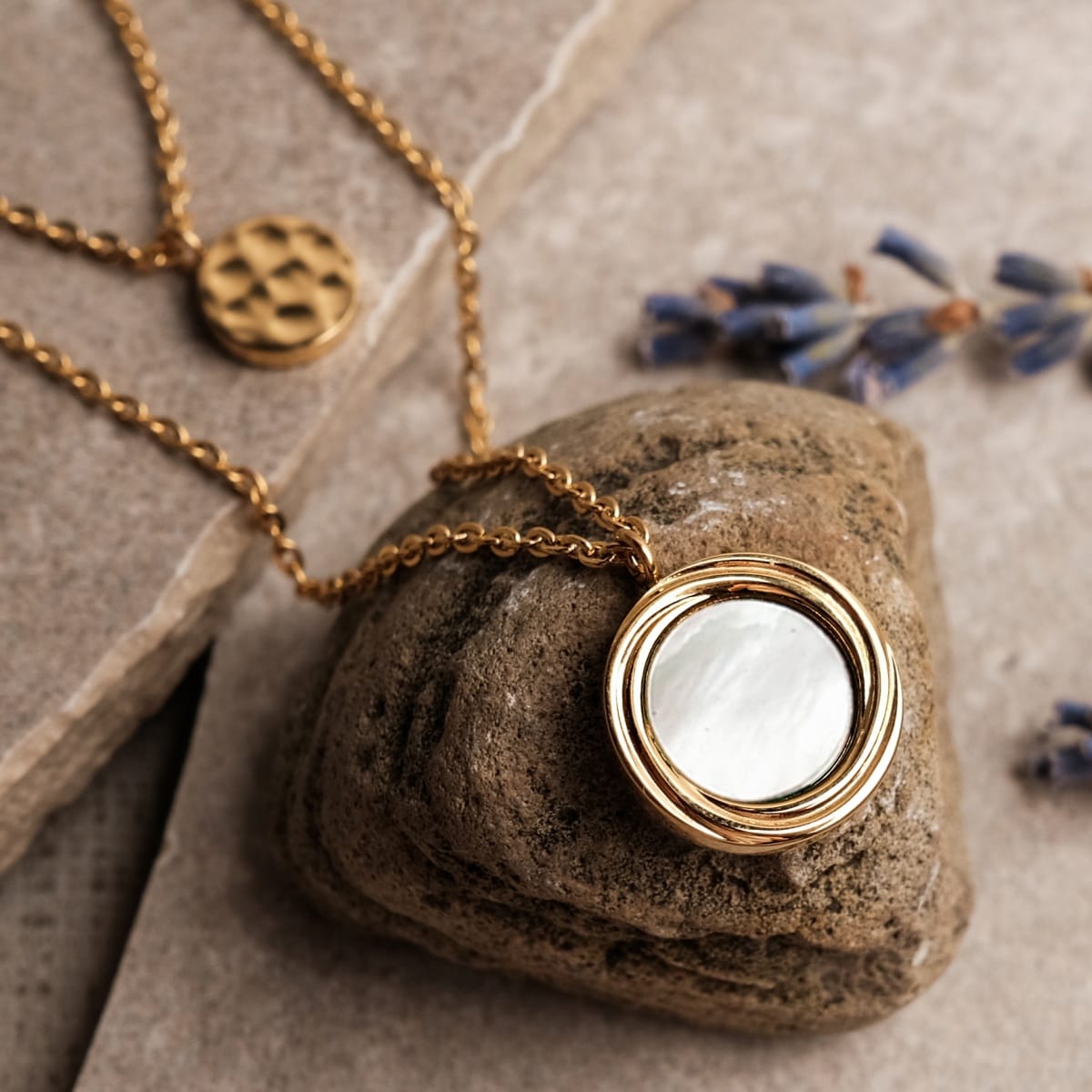 "Zendala Necklace" necklace featuring gold chain and white nacre pendant, exuding an elegant and natural style.