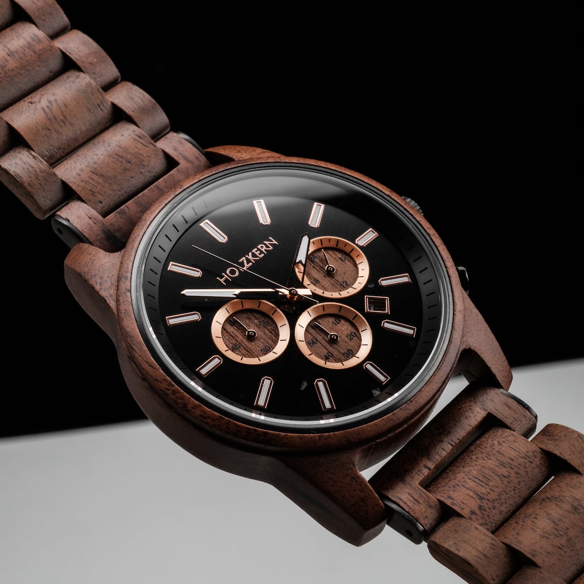 "Thicket" watch with walnut wood and marble accents, featuring a sleek black and copper design.