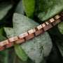 "Duet" bracelet with walnut wood and rose gold links, featuring a natural and elegant style.