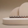 "Duet", a stylish product featuring walnut and silver materials, set against a minimalist beige backdrop.