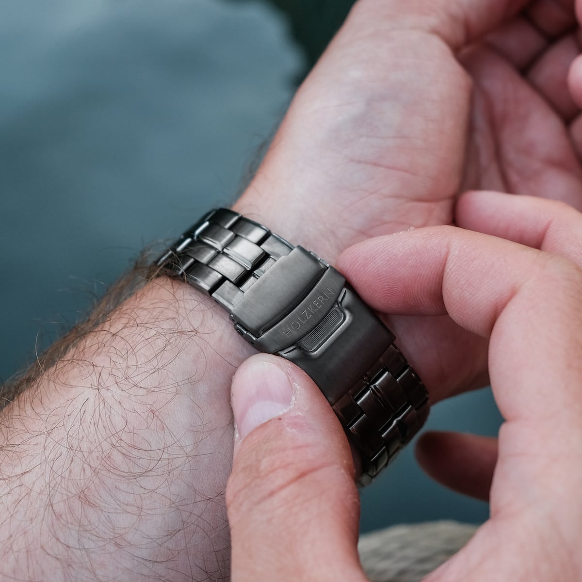 "Frostheave" watch showcasing a sleek marble and zebrawood design with a metal clasp.