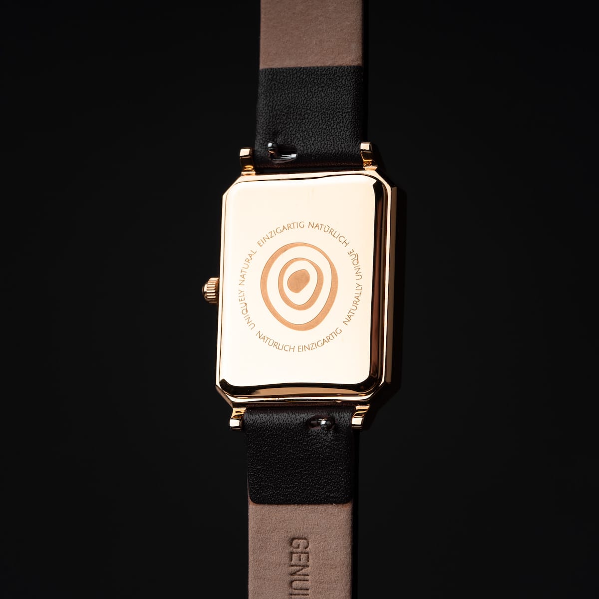"Auctoritas" watch in nacre and gold with a rectangular dial and elegant strap design.