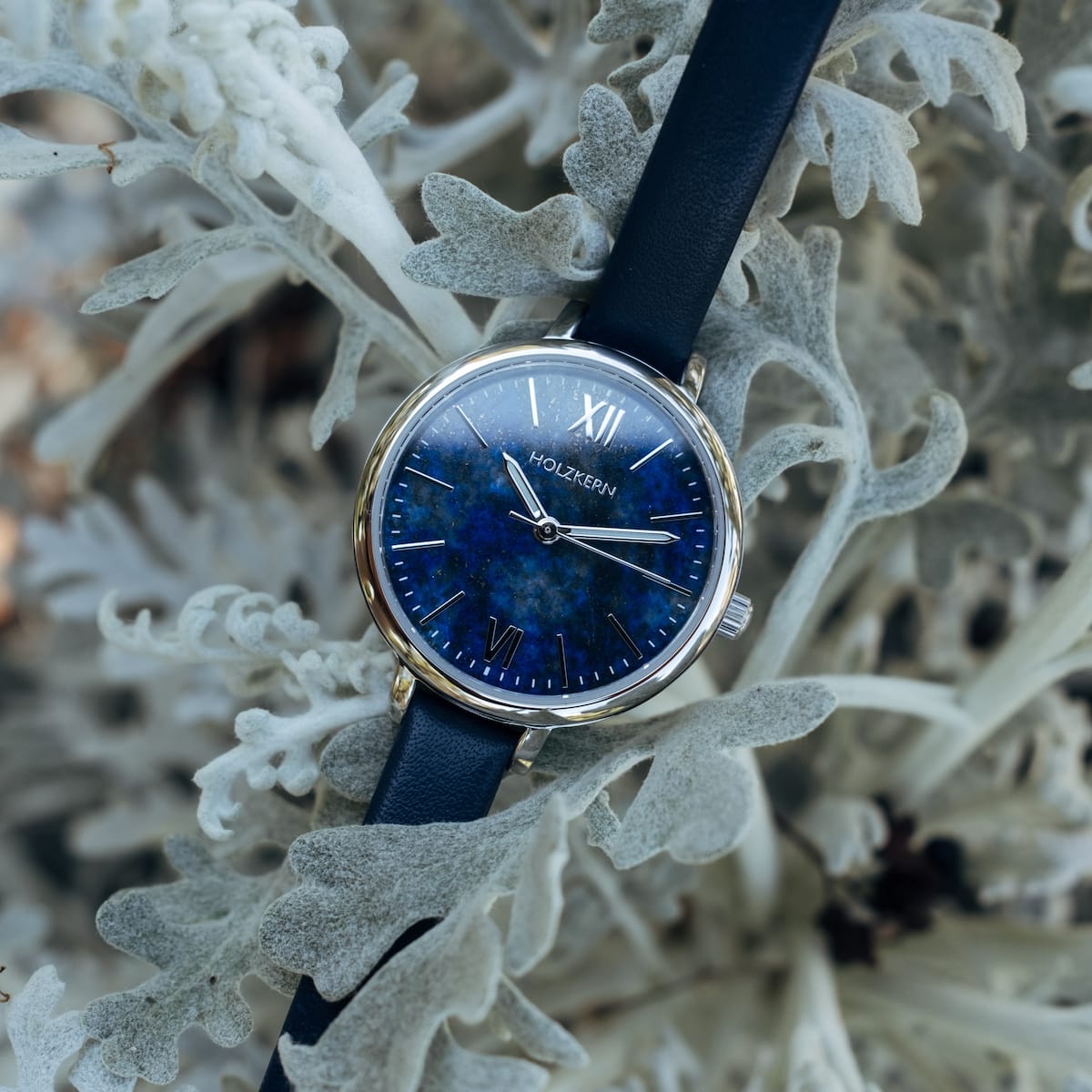 "Teresa" watch with a lapis lazuli face and silver accents, featuring a sleek design on a navy strap.